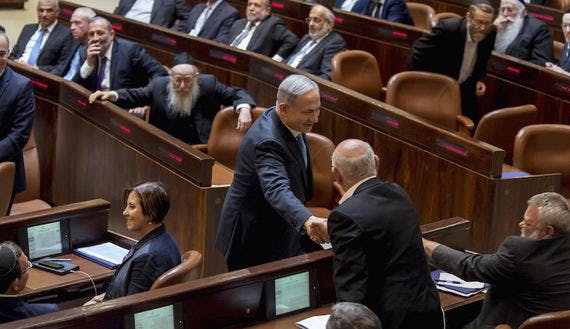 Israeli Prime Minister Netanyahu shakes hands with members of the opposition after he was sworn-in as Prime Minister for the fourth time, to lead the 34th Israeli government, at the Knesset, in Jerusalem
