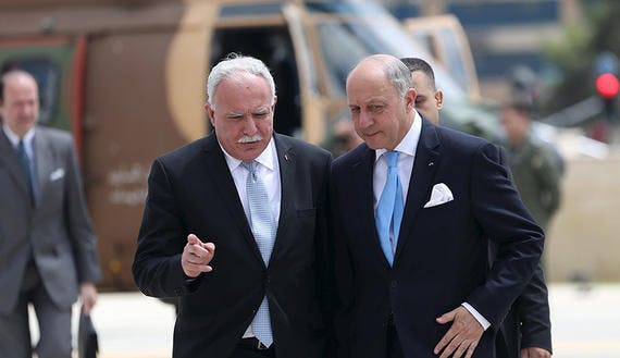France’s Foreign Minister Laurent Fabius is welcomed by Palestinian Foreign Minister Riyad al-Maliki upon Fabius’ arrival at the West Bank city of Ramallah