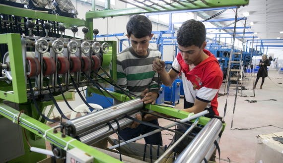 Palestinians work at a textile factory southwest of Nablus