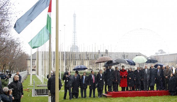 Palestinian President Mahmoud Abbas, UNESCO Director-General Irina Bokova and officials attend the flag raising ceremony for the Palestinian flag at UNESCO Headquarters in Paris