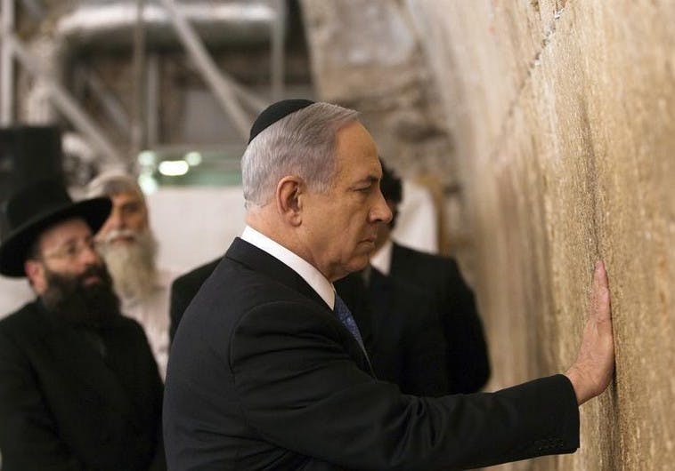 Israel’s Prime Minister Netanyahu touches the stones of the Western Wall in Jerusalem’s Old City