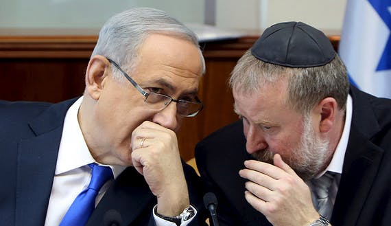 Israeli Prime Minister Netanyahu speaks with Cabinet Secretary Mandelblit during the weekly cabinet meeting in Jerusalem