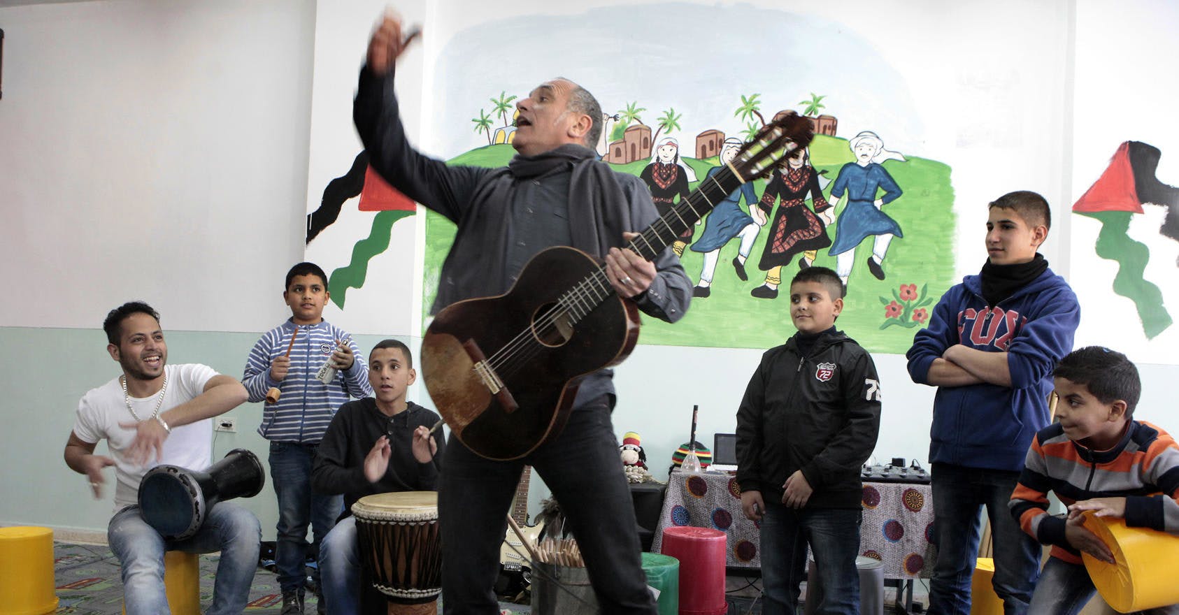 David Broza, an Israeli singer-songwriter, leads a workshop with Palestinian boys in the Shuafat neighborhood of East Jerusalem.