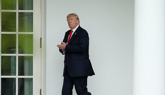U.S. President Donald Trump walks to the Oval Office at the White House in Washington