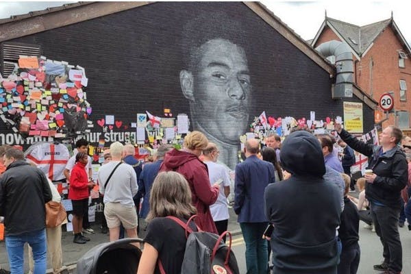 People place messages of support at a mural for Marcus Rashford in Manchester, after he received racist abuse after missing a penalty during the Euro 2020 final (Daniel Chesterton)