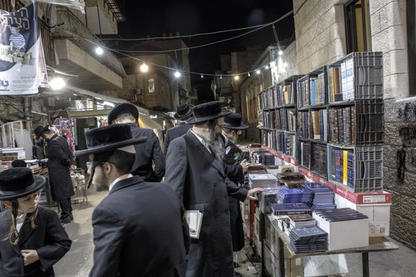 Members of the Neturei Karta browse books in Mea Shearim, Jerusalem