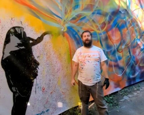 Yitzchak Moully with one of his street murals
