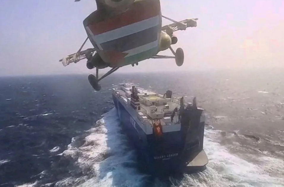 Helicopter hovering over ship at sea