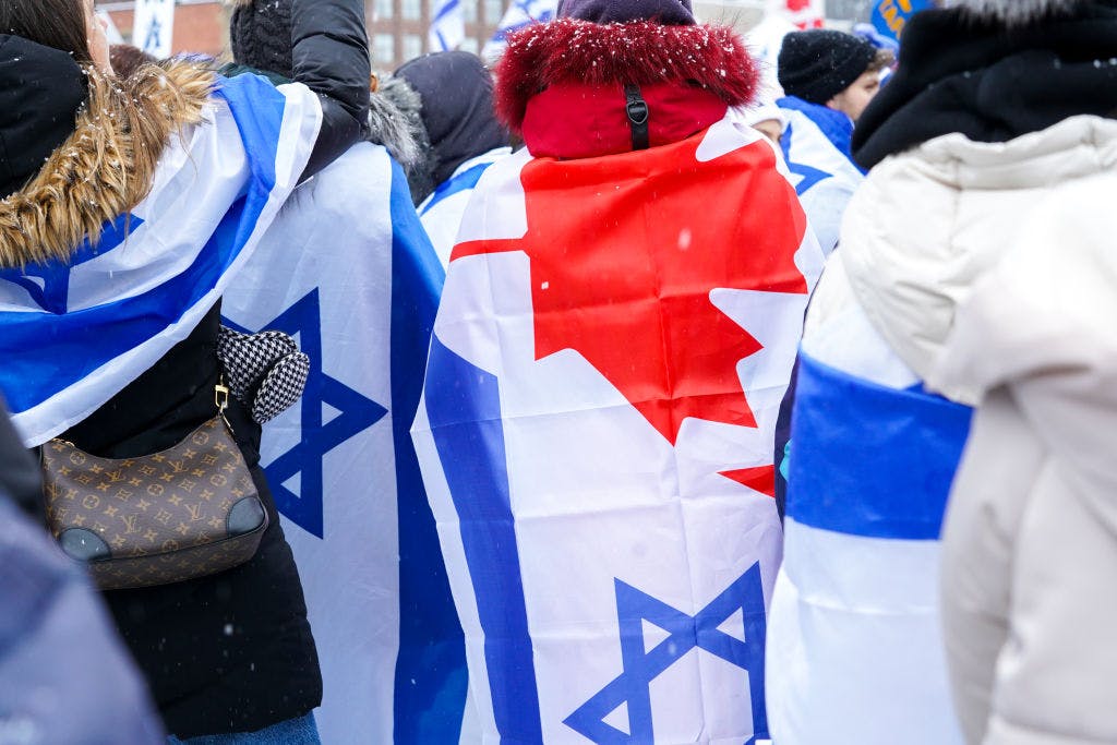 People draped in Israeli and Canadian flags