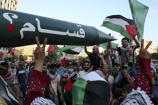 Palestinians in Lebanon chant slogans in front of a replica rocket in Beirut, May 18 (AP/Bilal Hussein)