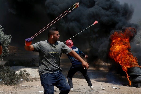 Palestinians throw stones at IDF troops after a demonstration against the expansion of Evyatar, July 16, 2021 (Alaa Badarneh)