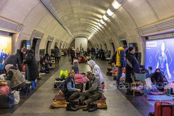 People inside Kyiv's Dorohozhychi subway station, now used as a bomb shelter (EPA/Roman Pilipey)