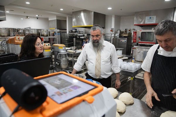 Laya Slavin and Rabbi Dovid Slavin with chef Dave Eley, known as Davo