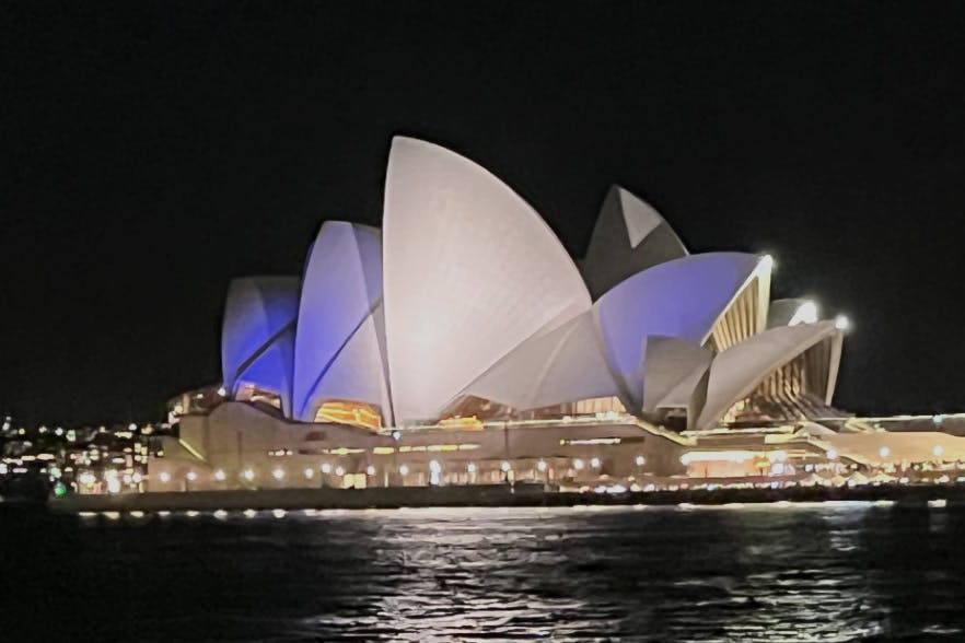 Sydney Opera House lit in blue and white