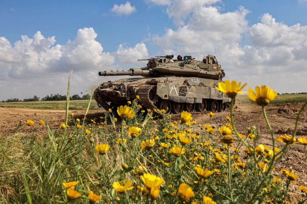 Tank in a field of yellow flowers